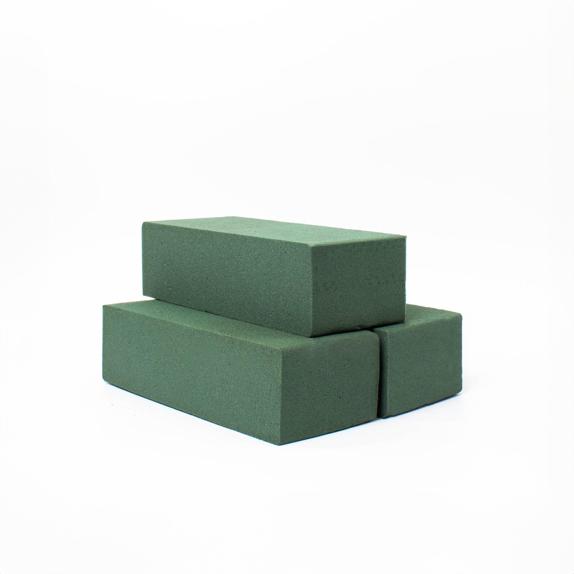 Green rectangular floral foam blocks on a white background.