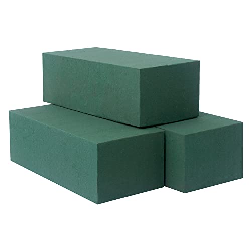 A close-up of three dark green rectangular floral foam blocks stacked together on a white background. One block is on top of two others, which are placed side by side.