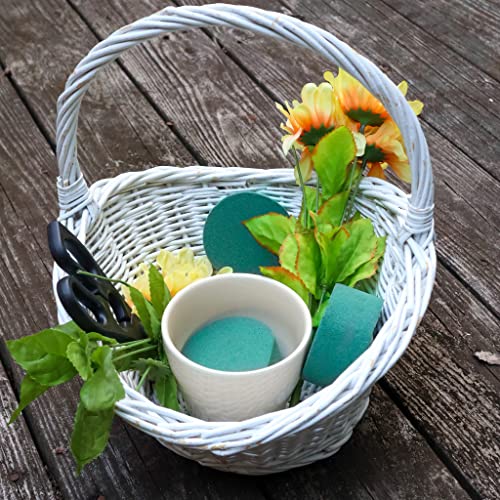 Artificial sunflowers in a white pot on a rustic wooden table.